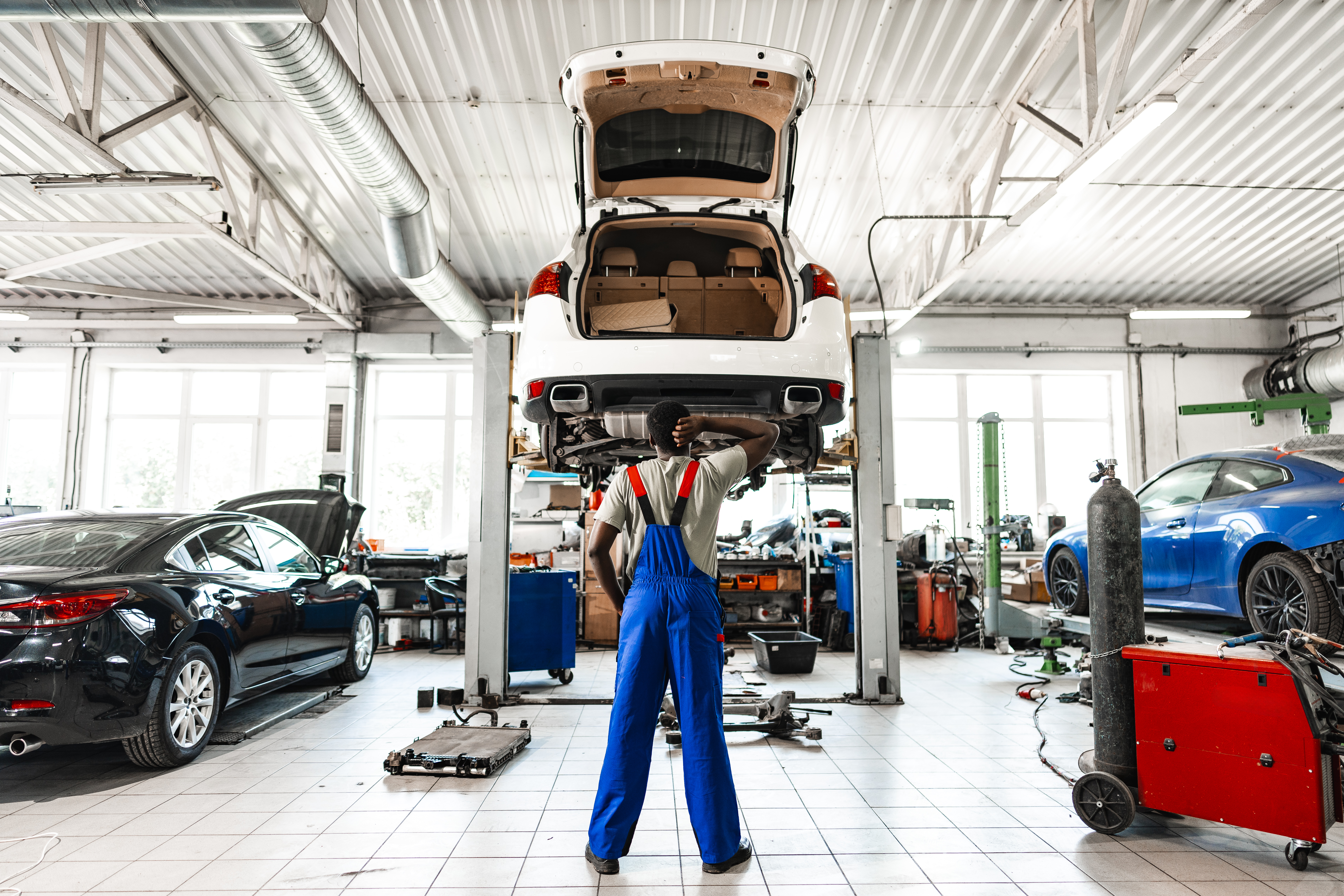 Mechanic carefully inspecting a vehicle system component